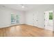 Bright bedroom with light hardwood floors, white trim, and French doors leading to outdoor deck at 380 Tidal Reef Cir, Mount Pleasant, SC 29464