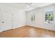 Bright bedroom with hardwood floors, two windows, white walls, and a ceiling fan at 380 Tidal Reef Cir, Mount Pleasant, SC 29464