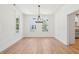 Open dining room with hardwood floors, neutral paint, and natural light from multiple windows at 380 Tidal Reef Cir, Mount Pleasant, SC 29464