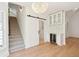 Foyer with wine bar, barn door, staircase, and wood flooring at 380 Tidal Reef Cir, Mount Pleasant, SC 29464