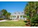 Charming home featuring a welcoming front porch, manicured lawn, and mature palm trees at 380 Tidal Reef Cir, Mount Pleasant, SC 29464