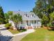 Charming home featuring a welcoming front porch, manicured lawn, and a well-maintained walkway at 380 Tidal Reef Cir, Mount Pleasant, SC 29464