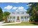 Charming single-Gathering home featuring a welcoming front porch, complemented by lush landscaping and a well-manicured lawn at 380 Tidal Reef Cir, Mount Pleasant, SC 29464