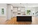Modern kitchen features white cabinetry, stainless steel appliances, and a dark center island at 380 Tidal Reef Cir, Mount Pleasant, SC 29464