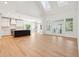 Bright living room with vaulted ceilings, skylights, and glass doors offers seamless indoor-outdoor living at 380 Tidal Reef Cir, Mount Pleasant, SC 29464