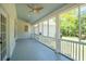 Screened porch with white railing, paneled walls, ceiling fans, and views of backyard at 380 Tidal Reef Cir, Mount Pleasant, SC 29464