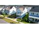 Aerial view of a two-story home with double porches, nestled in a well-planned neighborhood with manicured lawns at 403 Cool Bend Ln, Summerville, SC 29486