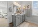 Bathroom featuring a double vanity with gray cabinets, a mirror, and decorative art at 403 Cool Bend Ln, Summerville, SC 29486