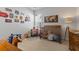 Bright bedroom featuring neutral walls and carpet, with whimsical 'Cars' themed decorations and a wooden crib at 403 Cool Bend Ln, Summerville, SC 29486