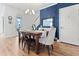 Well-lit dining room features modern chandelier, blue accent wall, and seating for four at 403 Cool Bend Ln, Summerville, SC 29486