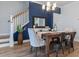 Bright dining area with decorative table, stair access, wood floors, and an accent wall at 403 Cool Bend Ln, Summerville, SC 29486