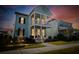 Charming two-story home with a double porch, showcasing a vibrant exterior paint under a beautiful dusk sky at 403 Cool Bend Ln, Summerville, SC 29486