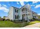 Stylish two-story home with a double porch and well-maintained lawn, creating a welcoming curb appeal at 403 Cool Bend Ln, Summerville, SC 29486