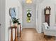 Bright foyer with hardwood floors, decorative table, and a view of the charming front door with a wreath at 403 Cool Bend Ln, Summerville, SC 29486
