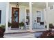 Charming front porch featuring rocking chairs, decorative accents, and a warm, welcoming ambiance at 403 Cool Bend Ln, Summerville, SC 29486
