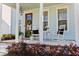 Inviting front porch with rocking chairs, stylish decor, and a hanging lantern, perfect for relaxing at 403 Cool Bend Ln, Summerville, SC 29486