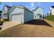 Exterior view of a well-maintained two-car garage featuring light blue siding and a concrete driveway at 403 Cool Bend Ln, Summerville, SC 29486