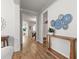 Hallway with wood floors leading to dining area, decorated with rustic wood table and blue decorative plates at 403 Cool Bend Ln, Summerville, SC 29486