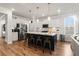 Bright kitchen with large island, seating, modern pendant lights, and stainless appliances at 403 Cool Bend Ln, Summerville, SC 29486