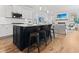 Kitchen with island seating overlooks the living area with fireplace and TV at 403 Cool Bend Ln, Summerville, SC 29486