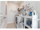 Well-lit laundry room featuring laundry machine, storage shelves, and decorative wall decals at 403 Cool Bend Ln, Summerville, SC 29486