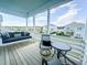 Inviting porch with a swing sofa, comfortable chairs, and views of the neighborhood at 403 Cool Bend Ln, Summerville, SC 29486