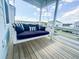 Cozy porch with a swing sofa and striped cushions, perfect for relaxation and enjoying the outdoors at 403 Cool Bend Ln, Summerville, SC 29486