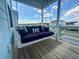 Relaxing porch featuring a swing sofa with striped cushions and neighborhood views at 403 Cool Bend Ln, Summerville, SC 29486
