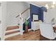 Elegant staircase with wood treads, white risers, and a decorative blue wall at 403 Cool Bend Ln, Summerville, SC 29486