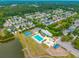 An aerial view of a community with a large pool, playground, a pond, and surrounded by lush green trees at 422 Verbena Ave, Summerville, SC 29483