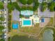 Bird's eye view of the neighborhood community pool, playground, and green spaces by a pond at 422 Verbena Ave, Summerville, SC 29483