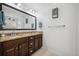Bathroom featuring double sink vanity with framed mirror, wood cabinets and towel rack at 422 Verbena Ave, Summerville, SC 29483