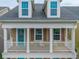 Welcoming two-story porch with white railings and an inviting turquoise front door at 422 Verbena Ave, Summerville, SC 29483
