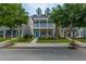 Charming two-story home with a well-manicured lawn and inviting front porch, with the US flag hanging at 422 Verbena Ave, Summerville, SC 29483