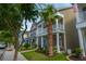 Inviting two-story home with a charming front porch adorned with colorful flowers and lush landscaping at 422 Verbena Ave, Summerville, SC 29483