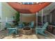 Charming brick patio with a fire pit surrounded by Adirondack chairs under string lights at 422 Verbena Ave, Summerville, SC 29483