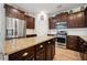 Spacious kitchen features island, granite countertops, stainless steel appliances, and dark wood cabinets at 422 Verbena Ave, Summerville, SC 29483