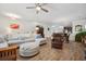 Open-concept living room and dining area featuring wood-look tile floors and a comfortable sectional sofa at 422 Verbena Ave, Summerville, SC 29483