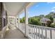 The inviting porch features seating and a view of the neighborhood at 422 Verbena Ave, Summerville, SC 29483