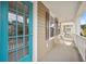 Inviting porch features a blue door, seating, and a view of the neighborhood at 422 Verbena Ave, Summerville, SC 29483