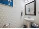 Elegant powder room with pedestal sink, decorative mirror, and stylish wallpaper at 422 Verbena Ave, Summerville, SC 29483