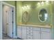 The bathroom has double sinks, granite countertops, tiled floors, and modern lighting at 4303 Misty Hollow Ln, Ravenel, SC 29470