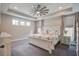 Relaxing bedroom featuring tray ceilings, a ceiling fan, and natural light from double windows at 4303 Misty Hollow Ln, Ravenel, SC 29470
