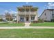 Charming two-story home featuring a double front porch and landscaped front yard at 4303 Misty Hollow Ln, Ravenel, SC 29470