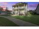 Lovely two-story home featuring double front porches at dusk with a well-kept lawn at 4303 Misty Hollow Ln, Ravenel, SC 29470