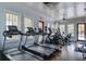 Bright gym with treadmills, hardwood floors, natural light from windows, ceiling fans, and access to the pool at 4303 Misty Hollow Ln, Ravenel, SC 29470