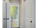 A hallway with white doors opens to a green tiled bathroom at 4303 Misty Hollow Ln, Ravenel, SC 29470