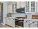 Contemporary kitchen features stainless steel appliances, white subway tile backsplash, and quartz countertops at 4303 Misty Hollow Ln, Ravenel, SC 29470