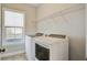 Clean laundry room with a window view and modern washer and dryer at 4303 Misty Hollow Ln, Ravenel, SC 29470