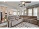 Bright living room with hardwood floors, a large sectional, and a view to the kitchen at 4303 Misty Hollow Ln, Ravenel, SC 29470